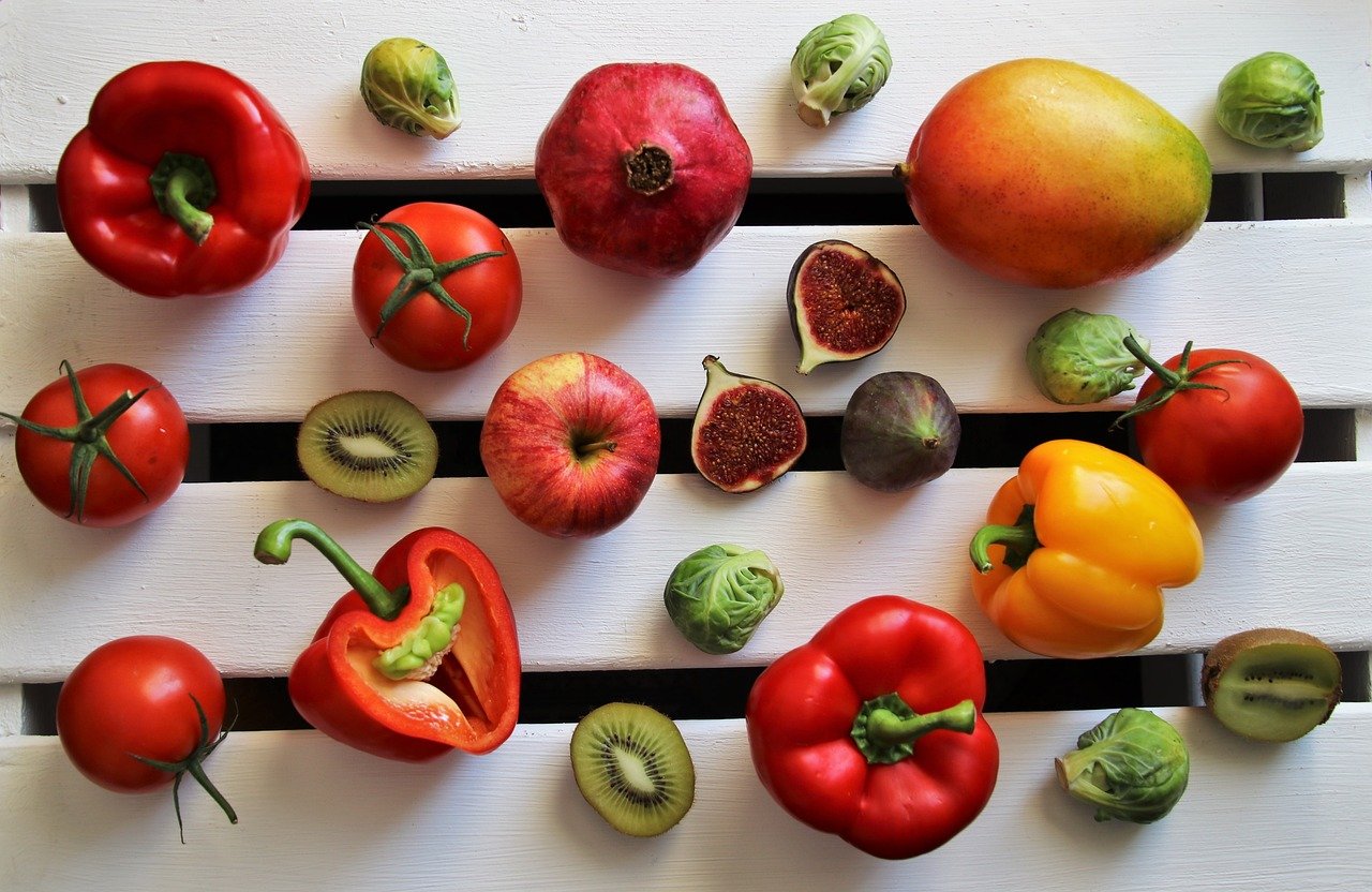 Fruits and vegetables lined up on a table.